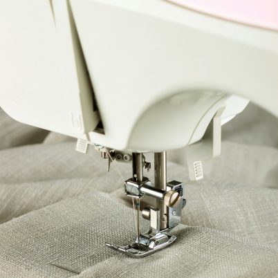 The modern sewing machine and item of clothing. sewing process.